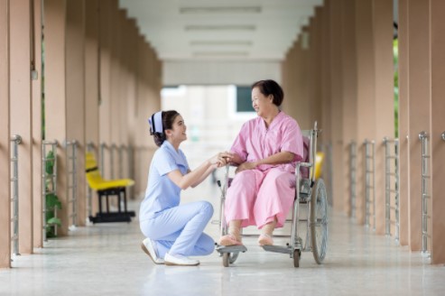 elderly woman being taken care of by a nurse